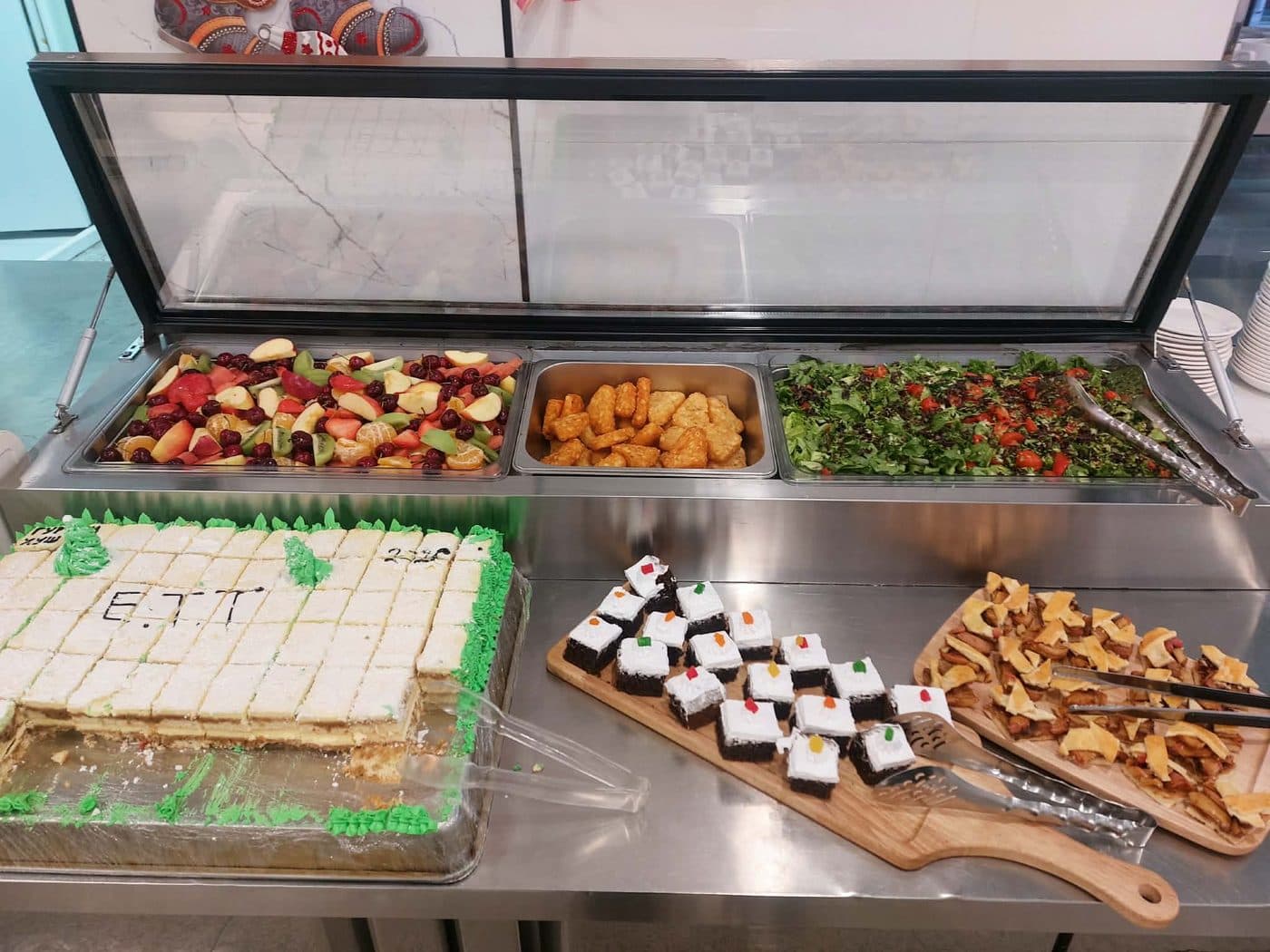 Hot food and desserts laid out on a buffet