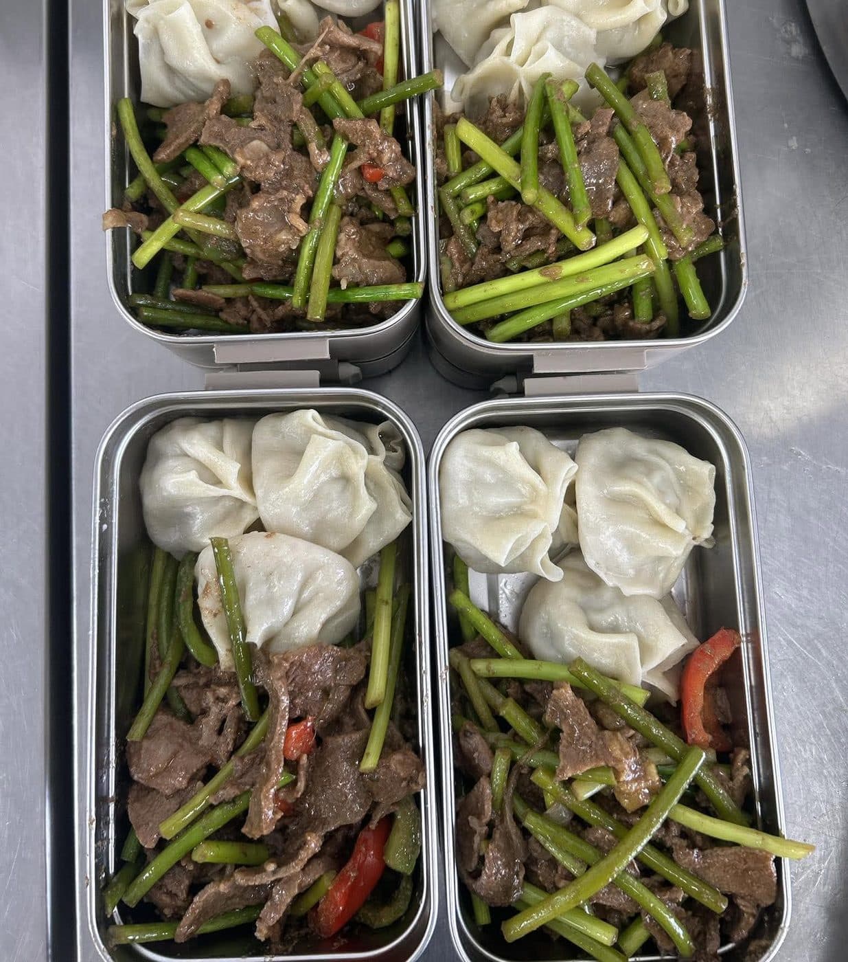 Steamed dumplings and meat prepared in trays