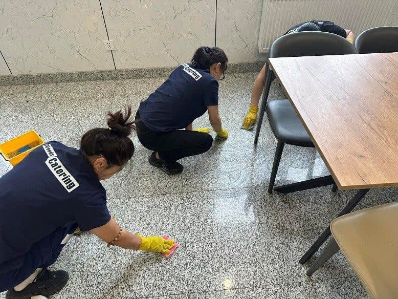 Cleaning staff working in a dining hall