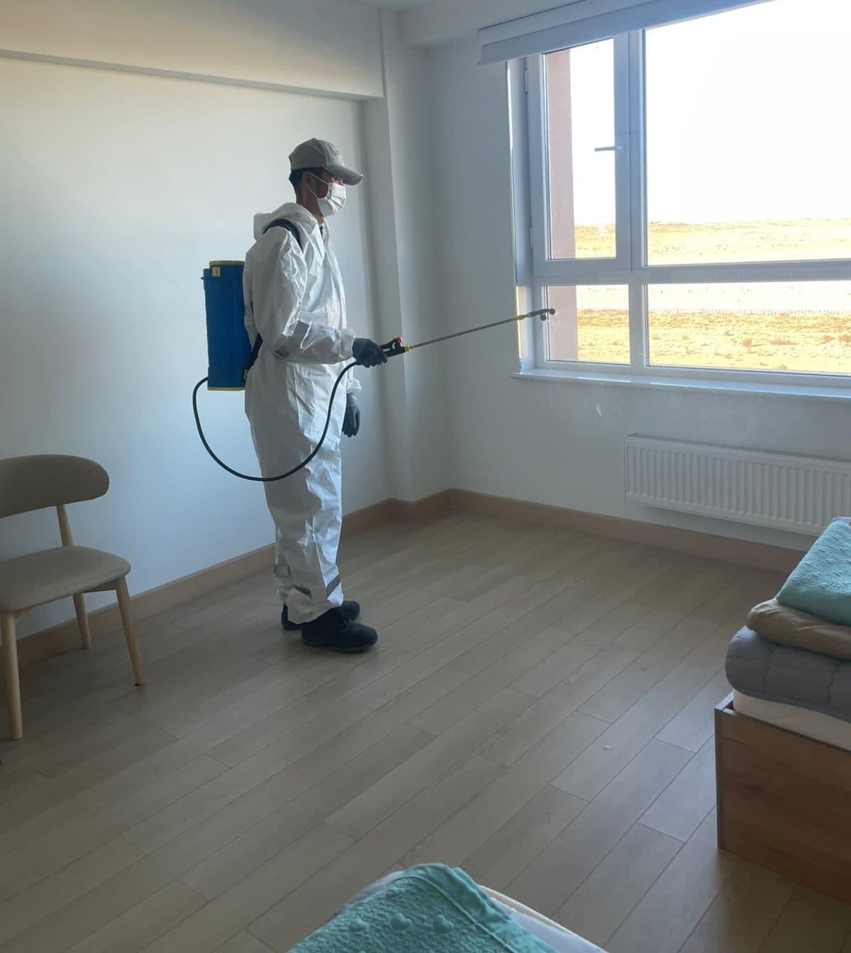 Staff disinfecting a camp room