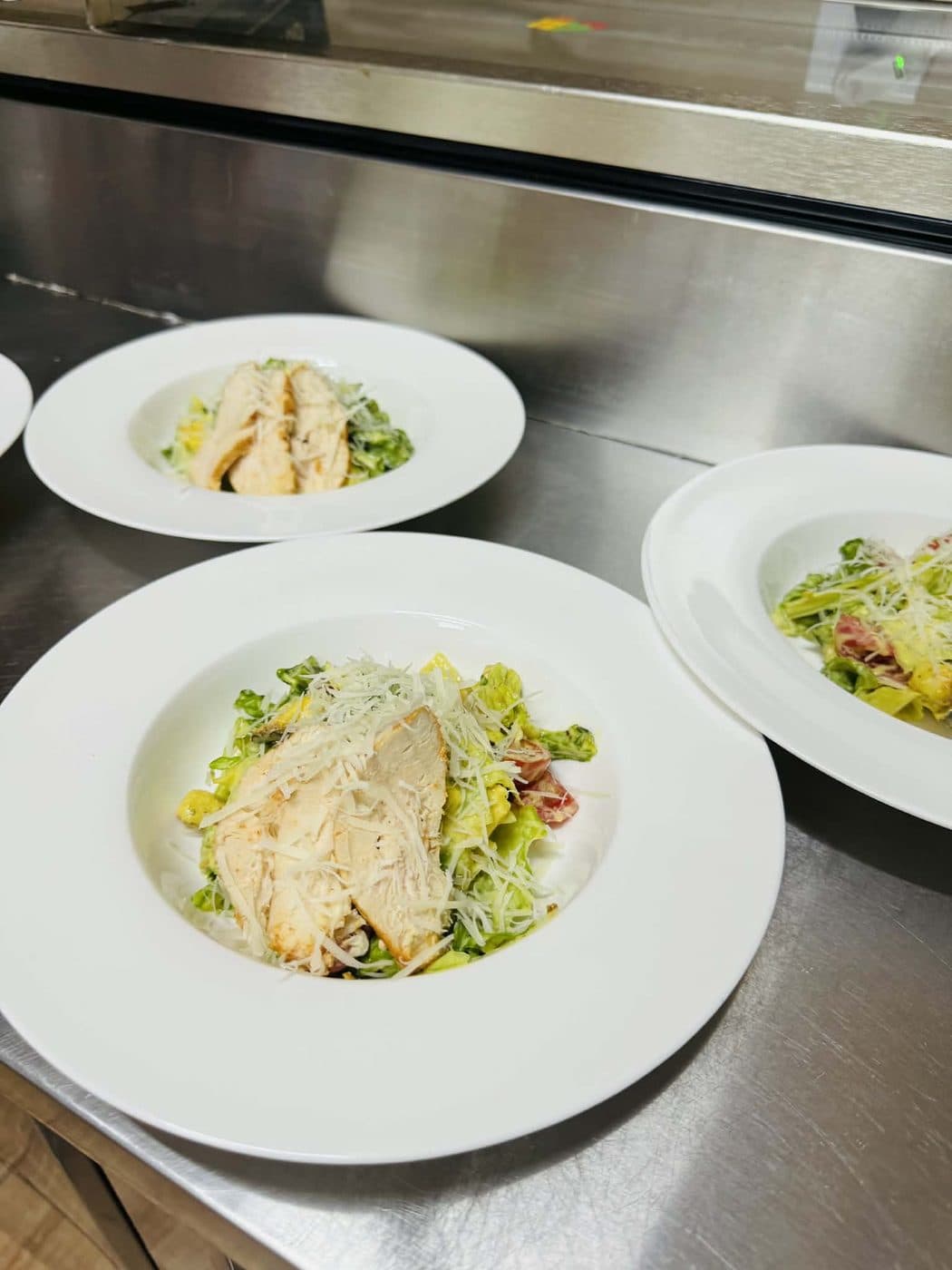 Caesar salad plated on white dishes
